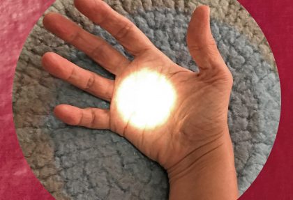 Open hand with the palm facing upwards in a blue-grey circle in a red square. There is a white circle of light in the centre of the palm.